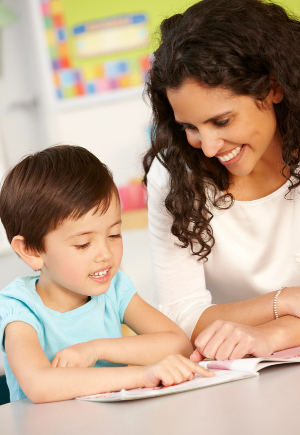 Teacher and Student Reading at Desk