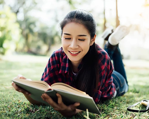 Girl Reading Book in Park