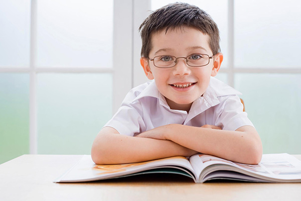 Boy reading at table