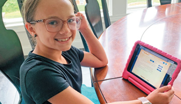 Girl using tablet with Reading Rangers Program