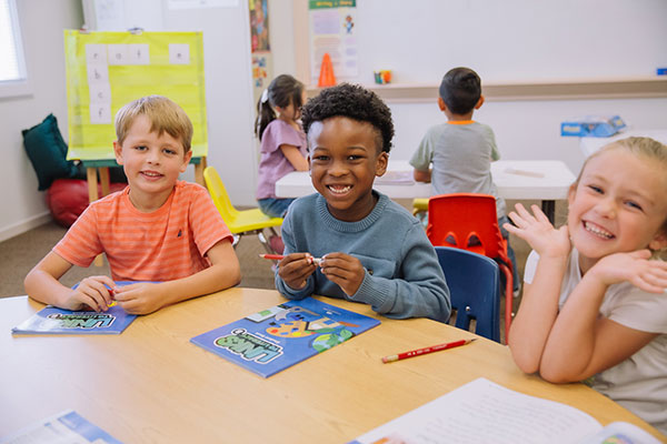 Kids smiling at table