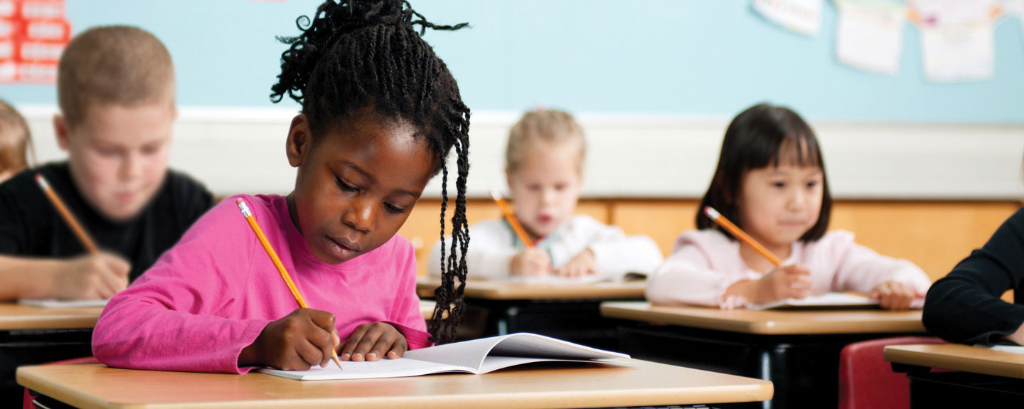 Students writing at desks